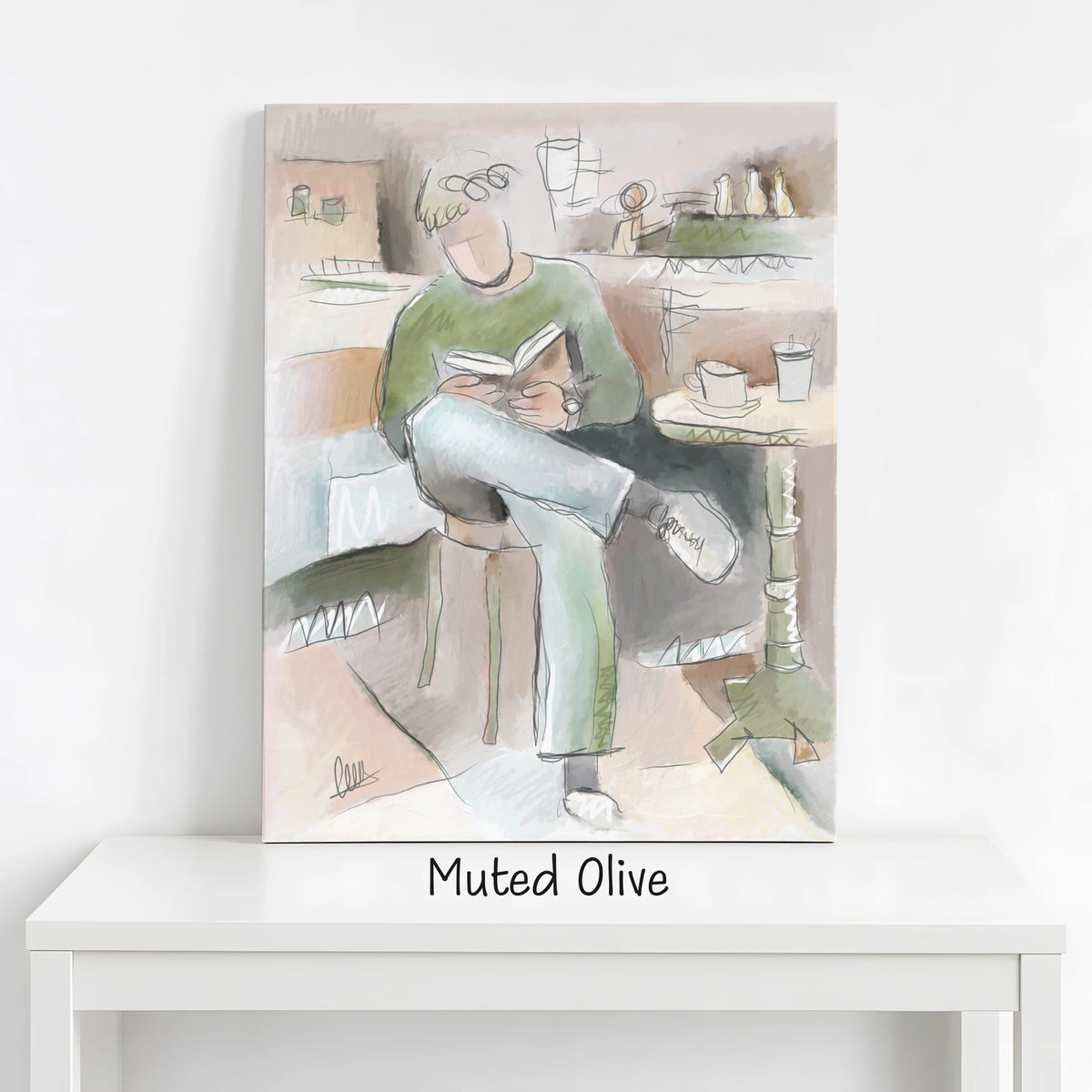 A vertical canvas art print featuring a muted, sketch-style artwork of a person sitting and reading, displayed on a white table against a white wall. The text 'Muted Olive' is printed below the canvas.